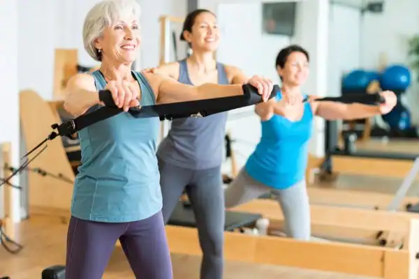 older woman doing weight training Sevenoaks and resistance in the gym to tone upper arms